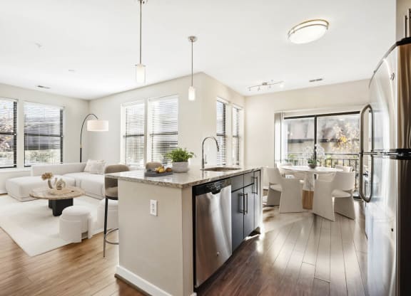 a white living room with a kitchen and a dining room