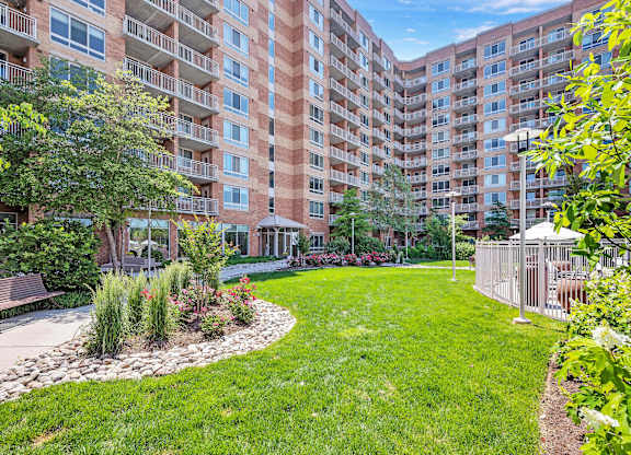 A large grassy area in front of apartment buildings.