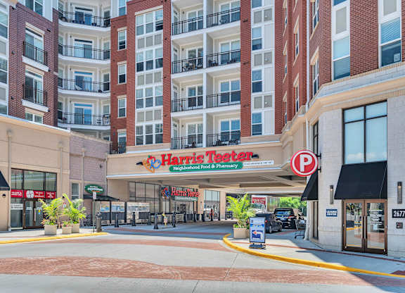 A Harris Teeter store is located in front of a large apartment building.