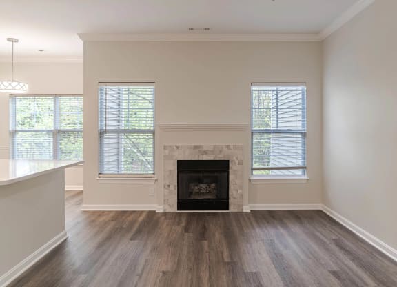 a living room with a fireplace and wooden floors