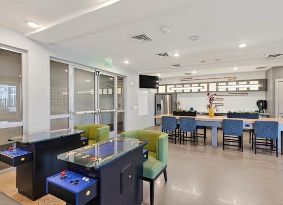 Indoor lounge with seating areas, billiards, and game room feature.
