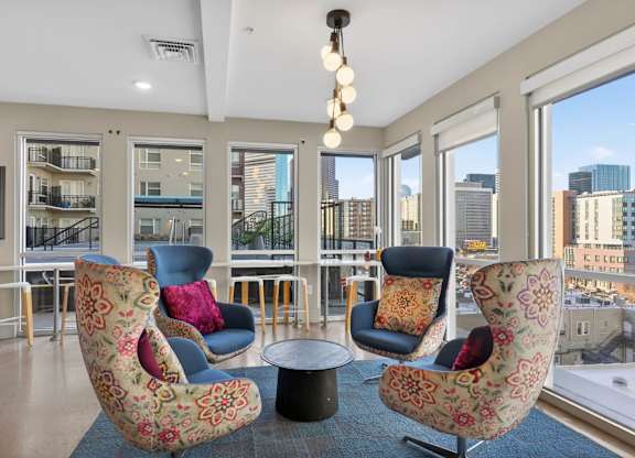 Modern indoor lounge with seating, game tables, and open common area.