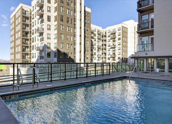 Outdoor pool with surrounding deck and seating.