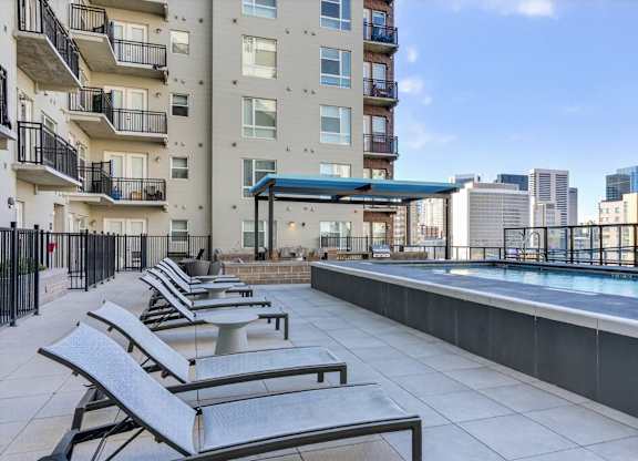 Pool area with lounge chairs.