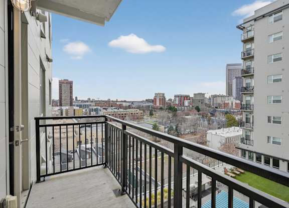 Apartment balcony with city skyline views.