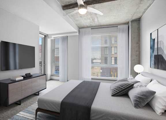 Contemporary apartment bedroom with large windows, neutral tones, and city views in Denver.