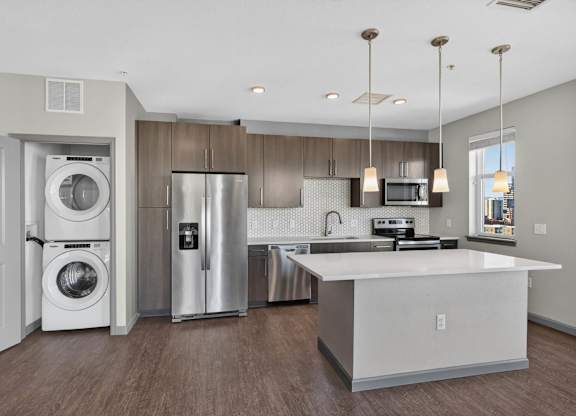 Luxury kitchen with wood cabinets and stainless steel appliances.
