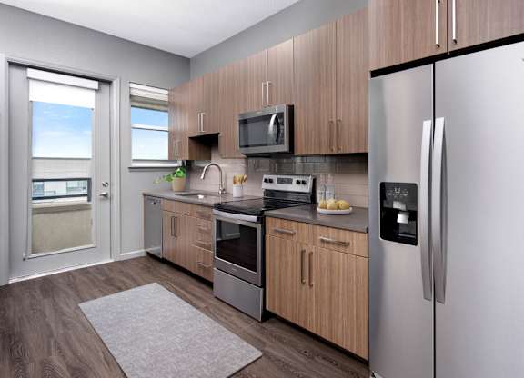 Modern apartment kitchen with stainless steel appliances and quartz countertops