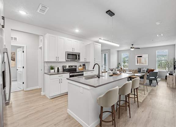 Furnished apartment featuring kitchen, island, and living room