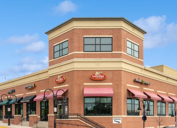 the outside of a burger king restaurant with pink awnings
