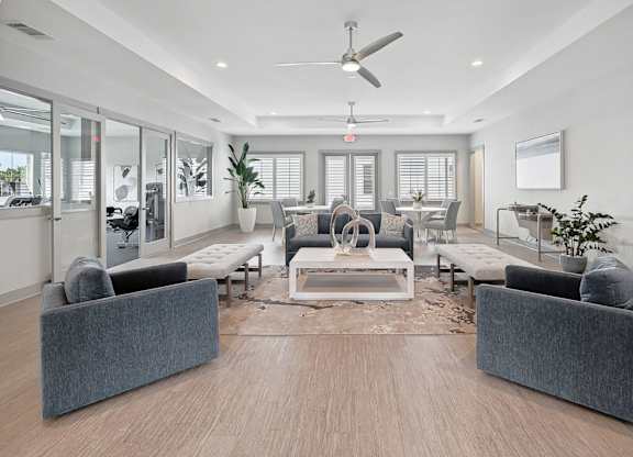 A modern living room with a grey sofa set and a wooden floor.