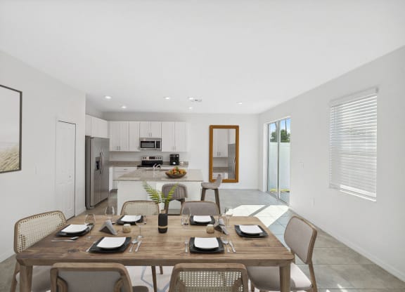 a dining area with a wooden table and chairs and a kitchen in the background