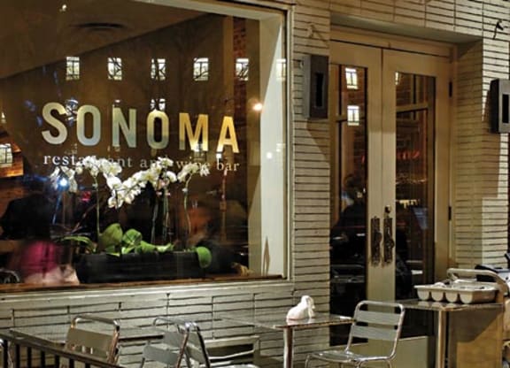a restaurant with tables and chairs in front of a window