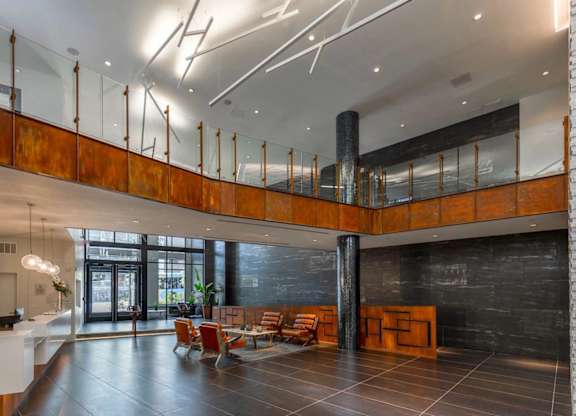A modern interior with a black floor and a white reception desk.