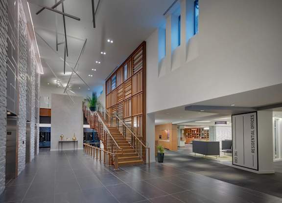 A modern interior space with a staircase and a glass wall.