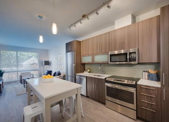 A modern kitchen with a dining table and chairs.