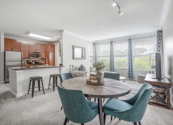 a living room with a kitchen and a dining table
