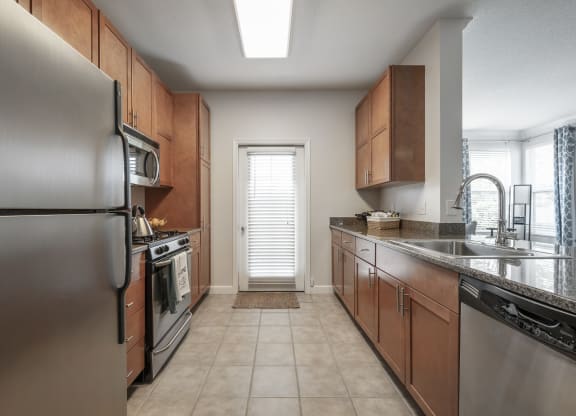 a kitchen with stainless steel appliances and wooden cabinets