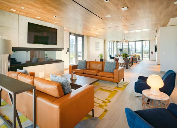 a living room and dining room with couches and chairs