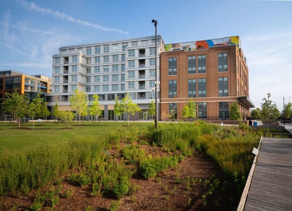 a park with a boardwalk in front of a building