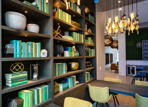 a dining room with a table and chairs and bookshelves