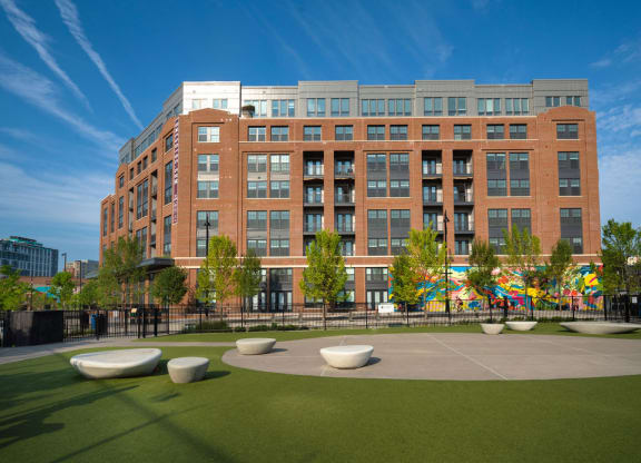 a large brick building with a courtyard in front of it
