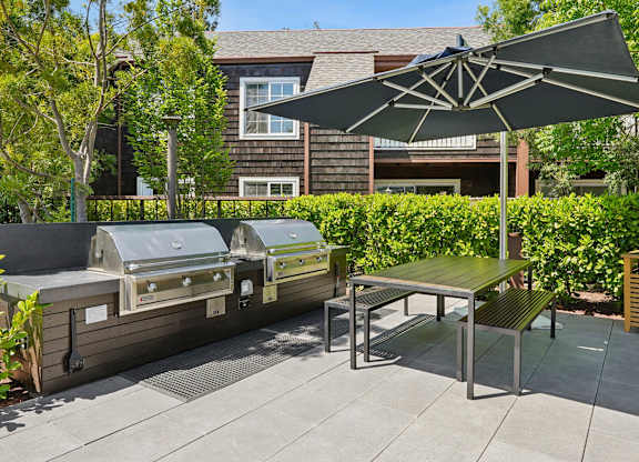 Outdoor grilling area at Sunnyvale apartments with landscaped surroundings