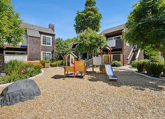 Community playground at Grove Apartments set within landscaped surroundings
