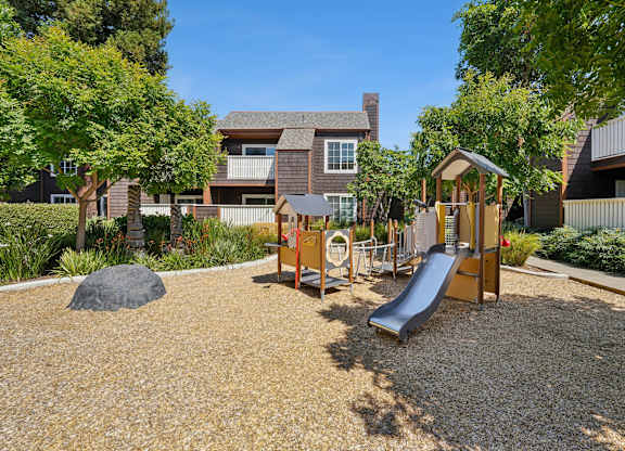 Outdoor playground at Grove Apartments with open space and play structures