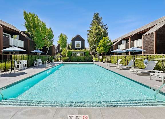 Swimming pool at Grove Apartments surrounded by landscaped grounds