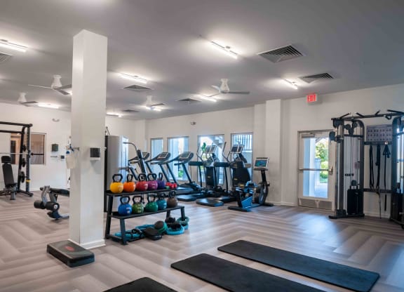 gym with weights and other exercise equipment at the bradley braddock road station apartments