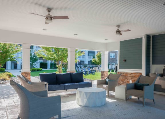 a patio with couches chairs and a coffee table