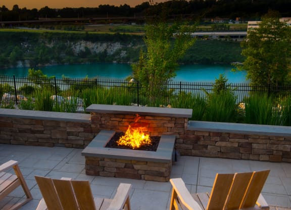 an outdoor fireplace with a view of the river