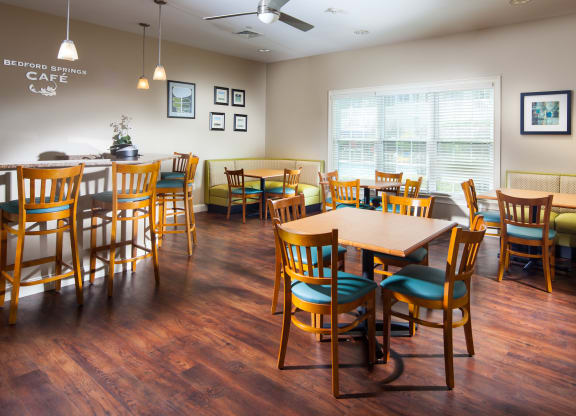 a dining room with tables and chairs and a couch