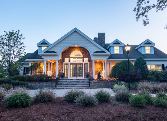 the front of a house at night with the front porch lit