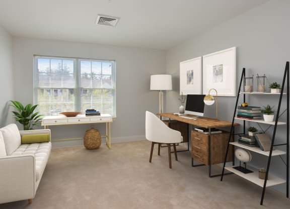 a home office with a white couch and a desk with a computer