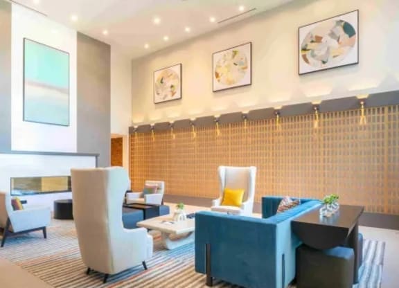a lobby of a hotel with a blue couch and chairs