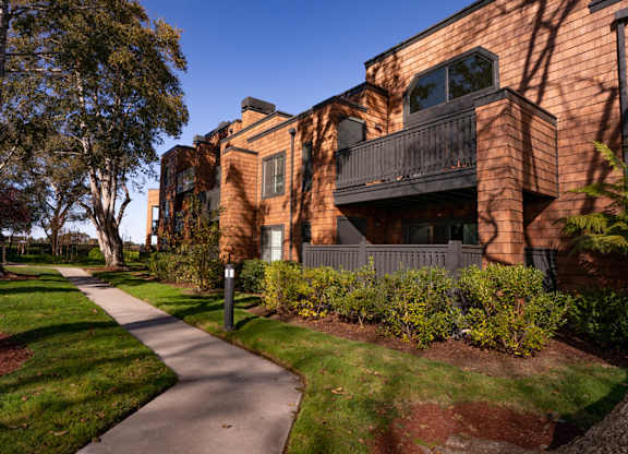 Apartment grounds with lush greenery and landscaped paths at Indian Creek in Redwood City