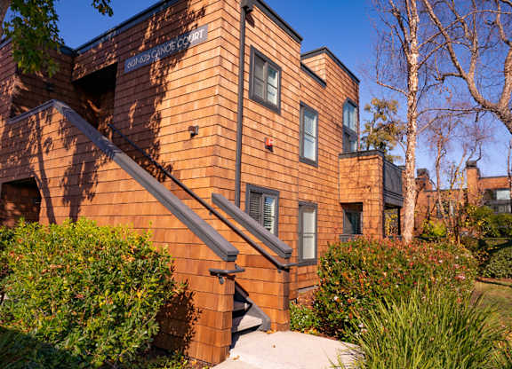 Apartment grounds with lush greenery and landscaped paths at Indian Creek in Redwood City