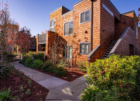 Apartment grounds with lush greenery and landscaped paths at Indian Creek in Redwood City
