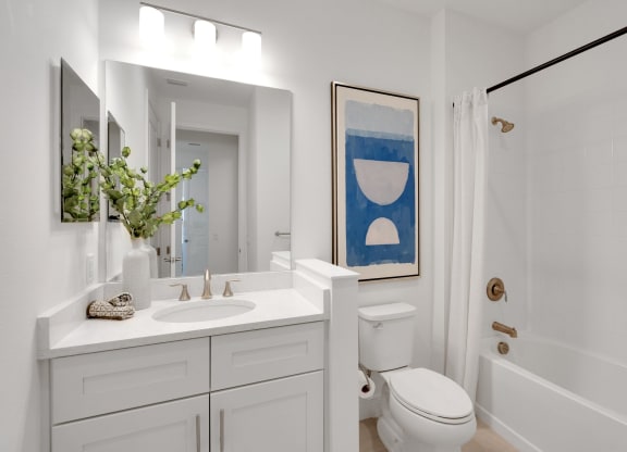 a white bathroom with a toilet sink and shower at Marisol, Bradenton FL