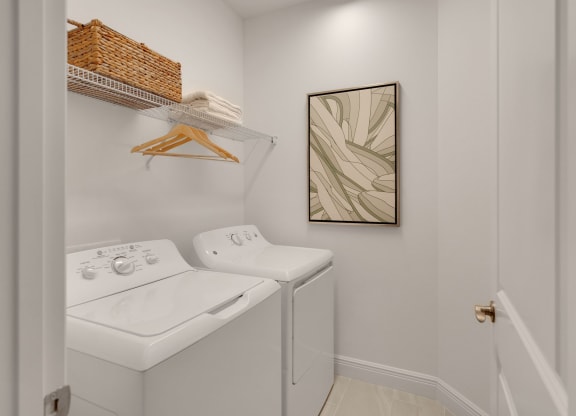 a laundry room with a washer and dryer and a painting on the wall at Marisol, Bradenton, FL 34211