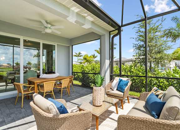 A patio with a table and chairs is shown at Marisol in Lakewood Ranch, FL