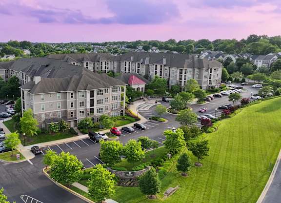 A large building with a parking lot in front of it.