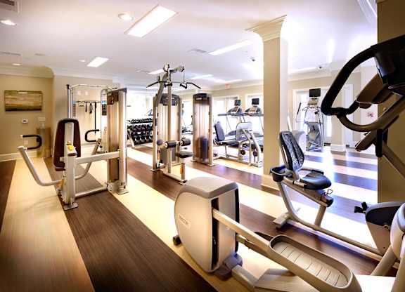 A gym with a variety of exercise equipment.