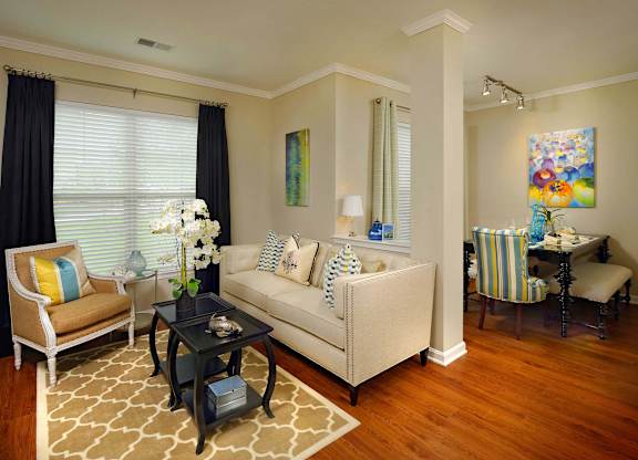 A living room with a sofa, chairs, and a coffee table.