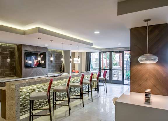 A modern bar area with a television on the wall.