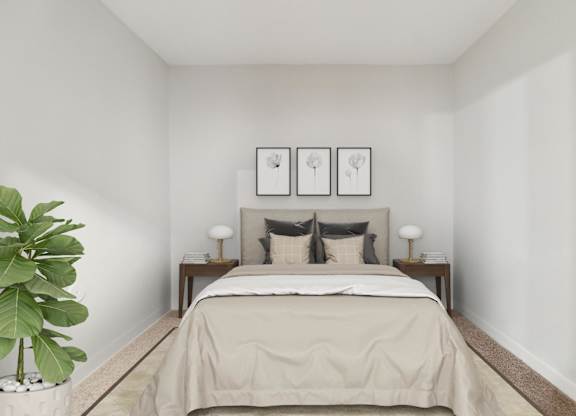 A bedroom with a bed, two lamps, and two pictures on the wall.