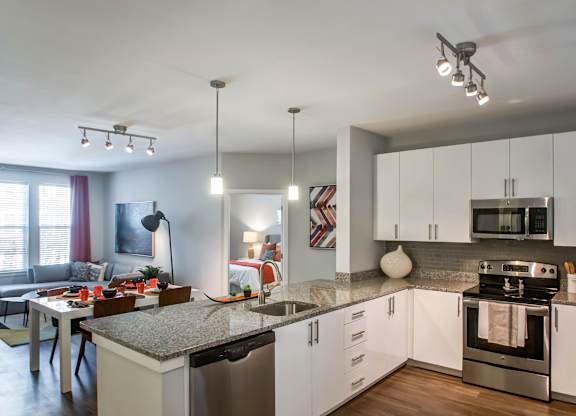 A modern kitchen with a dining table and chairs.