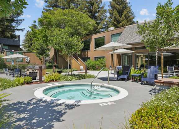 Outdoor hot tub with lounge seating at Old Orchard Apartments